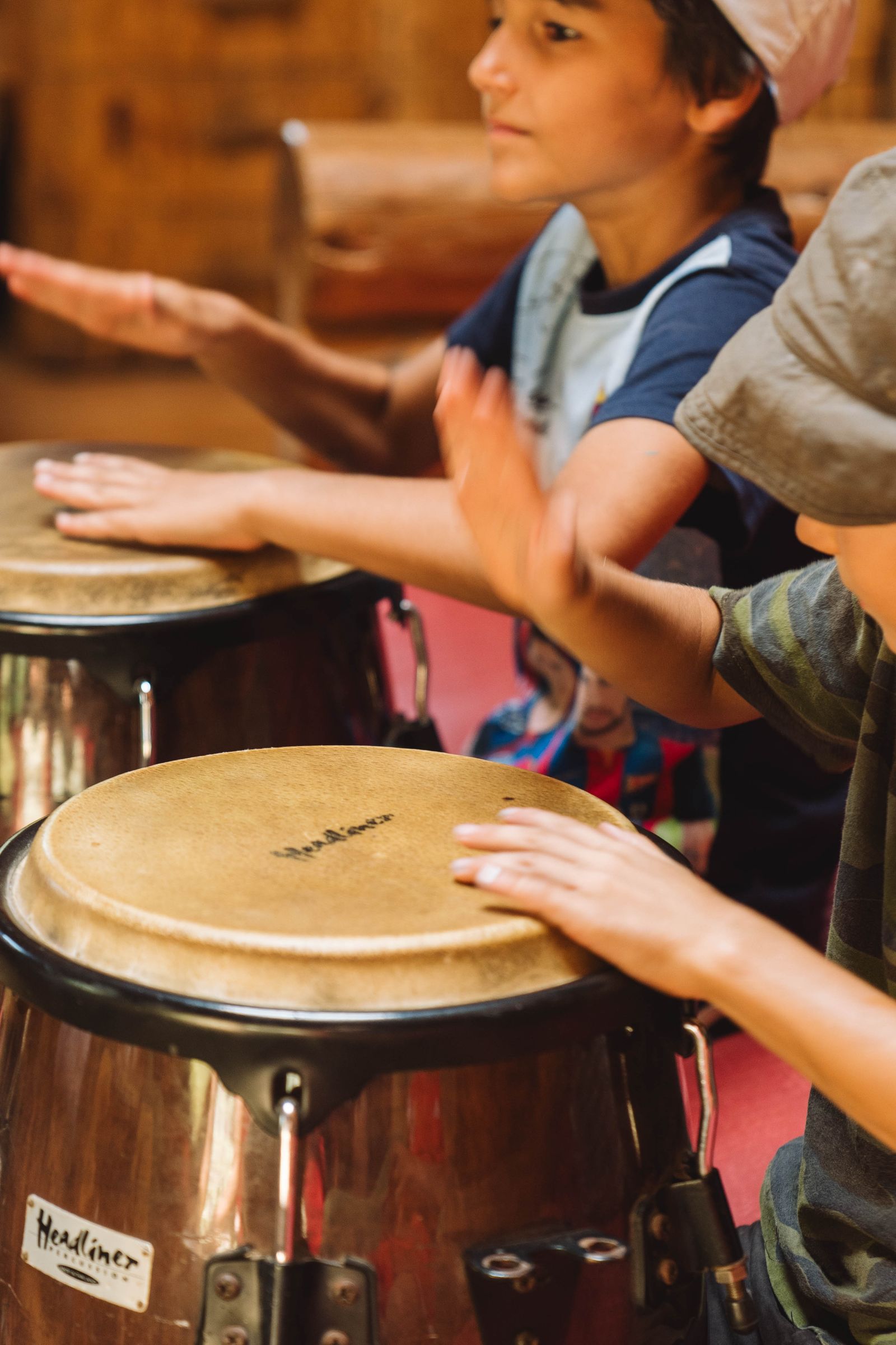Children playing hand drums in a high-energy rhythm workshop