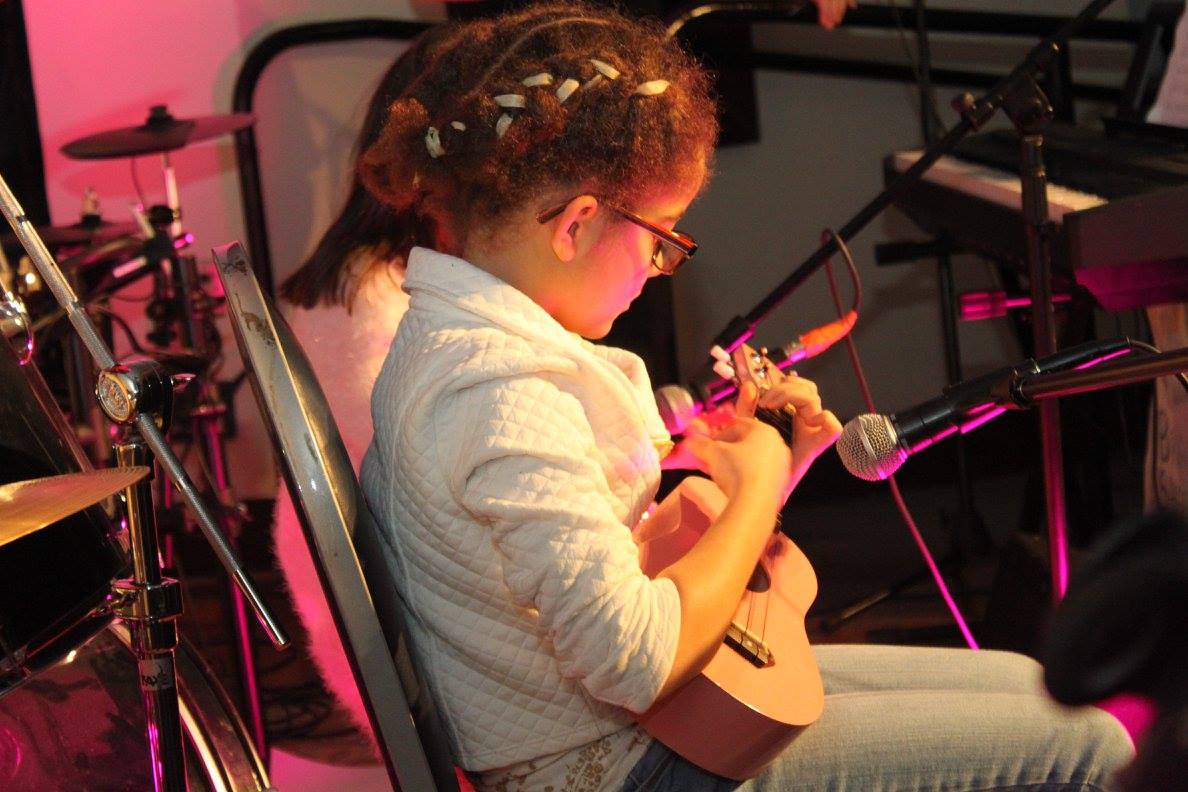Group Jam — students rotating through rock-band instruments