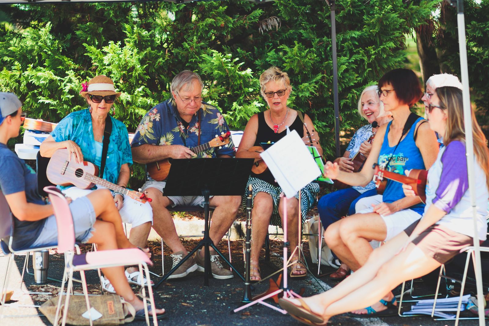 Adults playing ukuleles together in a group music-therapy session