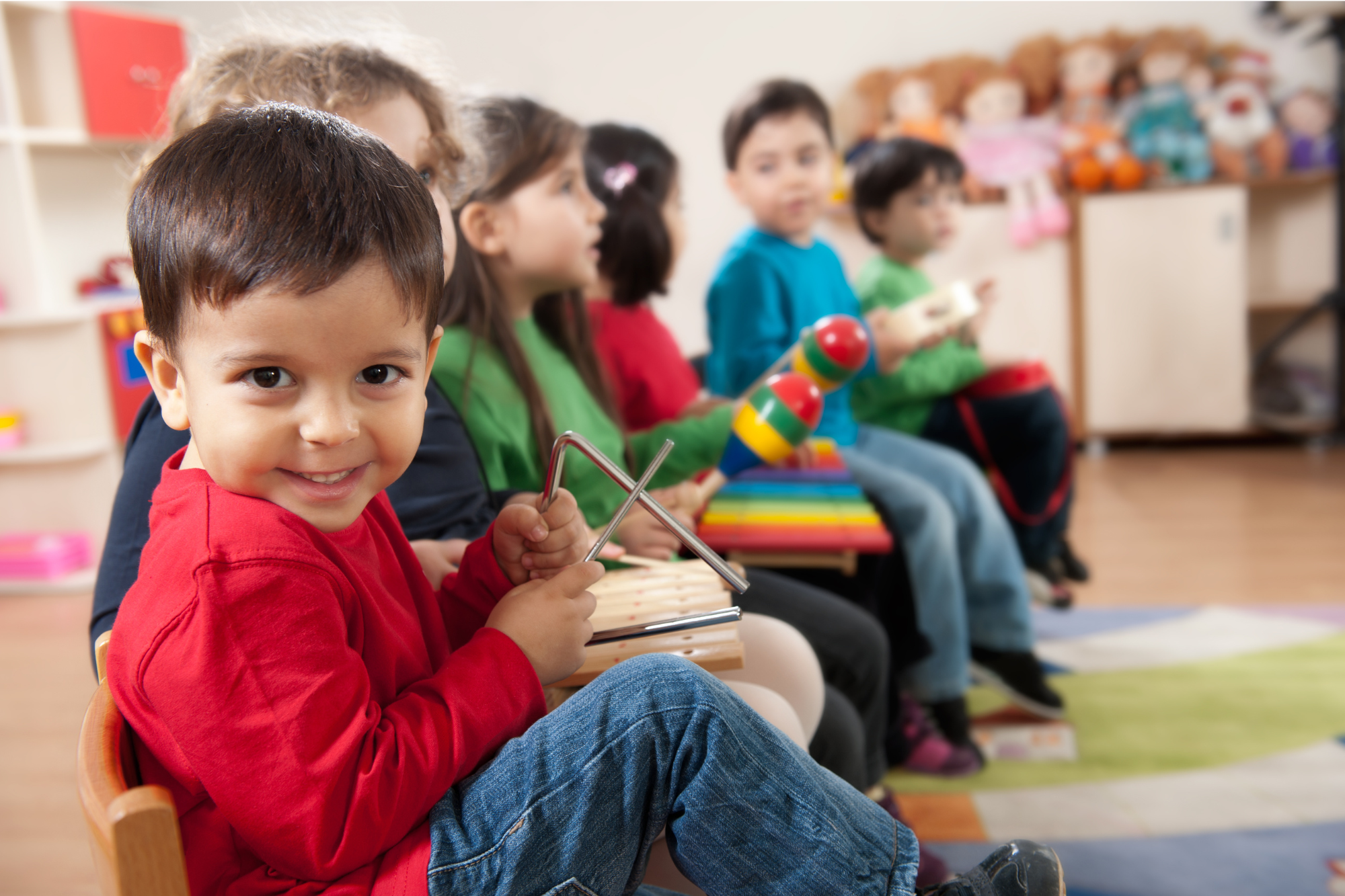 Young children and caregivers in an early-childhood music class — Little Rockers