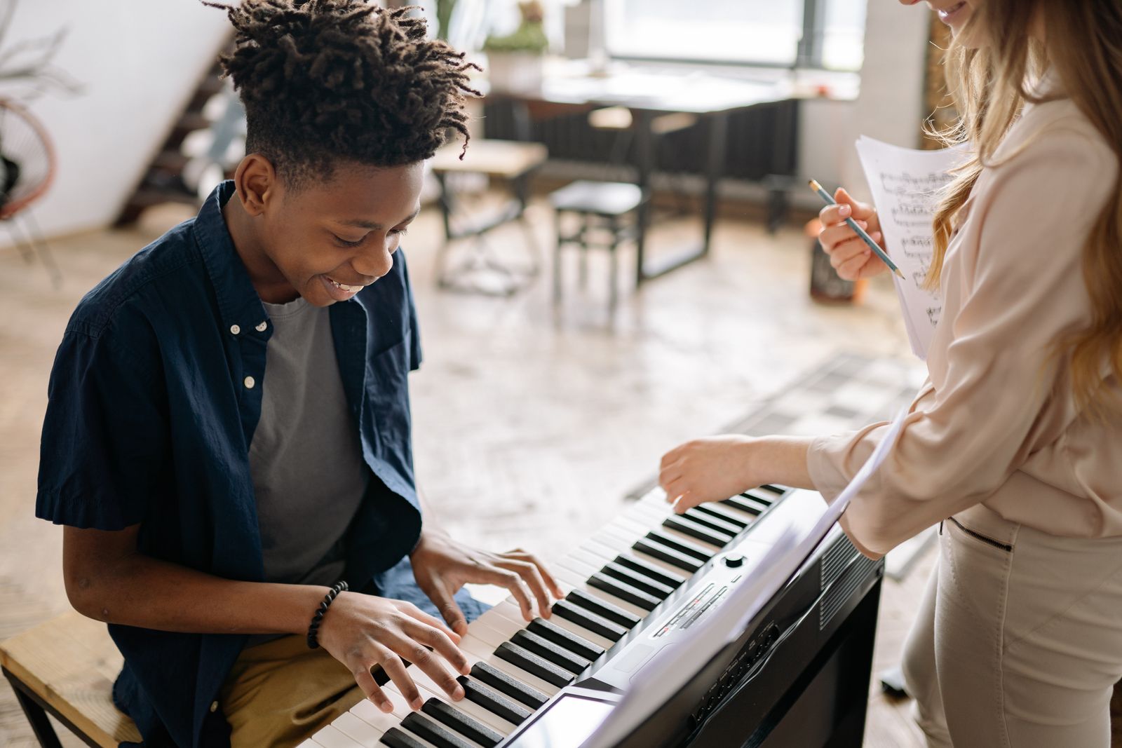 A child learning piano in a small-group Piano Adventures class
