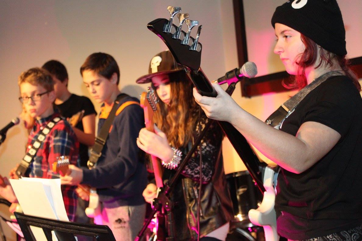 After-school Rockstar Guitar class — students with electric guitars